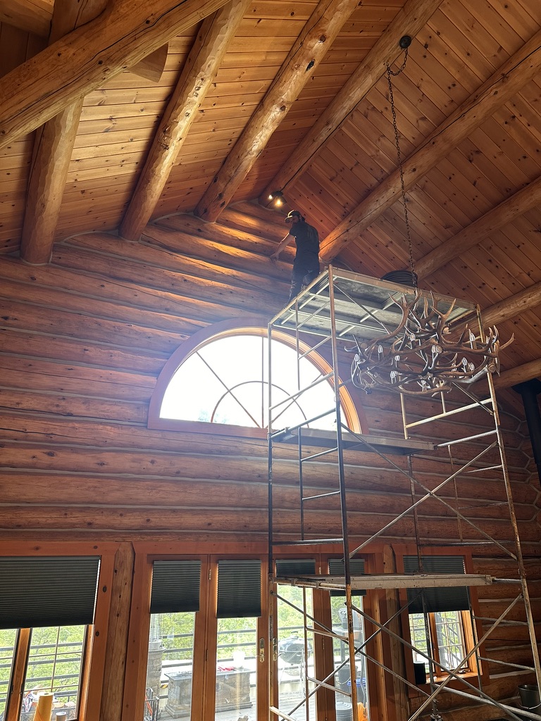 Interior log home restoration work from scaffolding