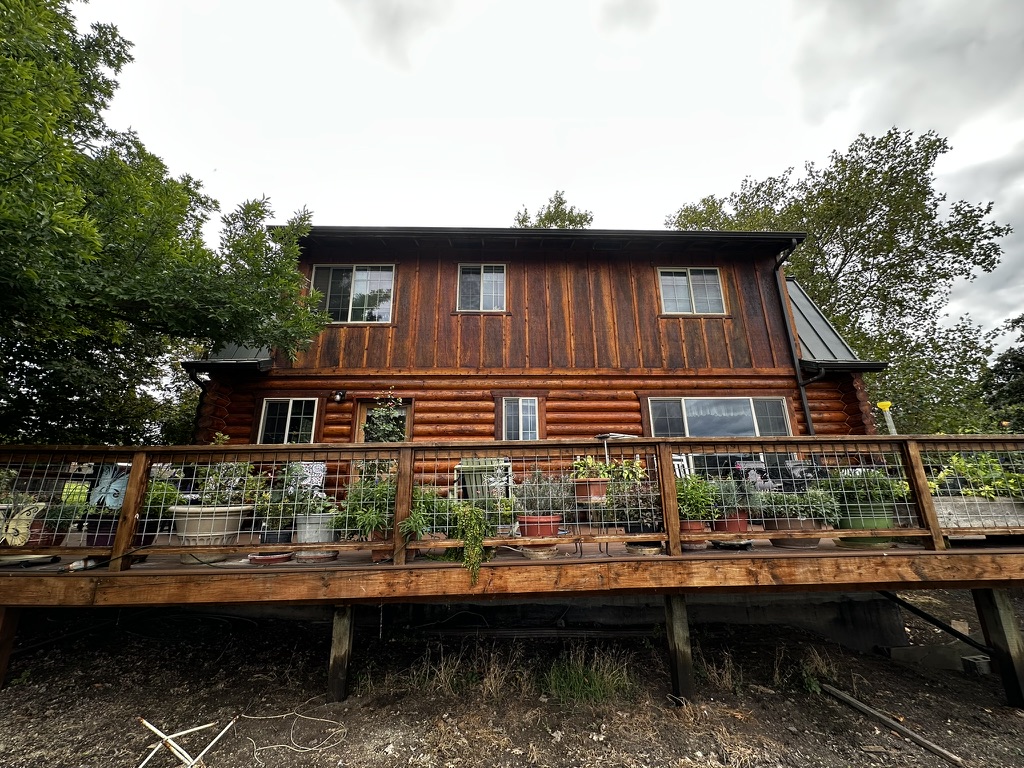 Restored two-story log home with a garden deck